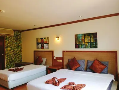 a hotel room with two beds with bows on them at Haweli Restaurant & Guest House in Ao Nang Beach