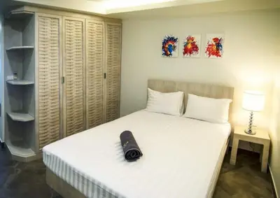 a bed with a black shoe sitting on top of it at Karon beach Stylish large 2BR with Sea View in Karon Beach
