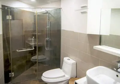 a bathroom with a shower and a toilet and a sink at Karon beach Stylish large 2BR with Sea View in Karon Beach