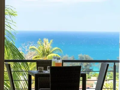 a table and chairs with a view of the ocean at Karon beach Stylish large 2BR with Sea View in Karon Beach