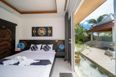 a bedroom with a bed and a balcony at Luxurious 8bedroom villa in Bangtao Large private pool Group vacation villa Free maid and private kitchen service Extended in Bang Tao Beach