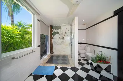 a bathroom with a black and white checkered floor at Luxurious 8bedroom villa in Bangtao Large private pool Group vacation villa Free maid and private kitchen service Extended in Bang Tao Beach