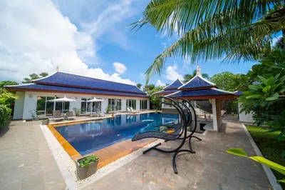 a swimming pool in front of a villa at Luxurious 8bedroom villa in Bangtao Large private pool Group vacation villa Free maid and private kitchen service Extended in Bang Tao Beach