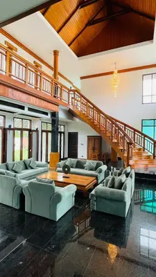 a large living room with couches and a staircase at Kiri Anda Villa Phuket in Rawai Beach