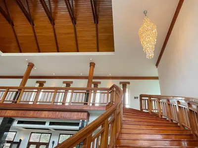 an empty church with wooden stairs and a chandelier at Kiri Anda Villa Phuket in Rawai Beach