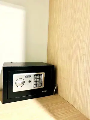 a microwave oven sitting on top of a bed at Veloche group in Karon Beach