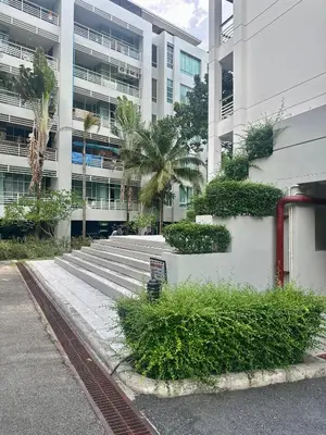 a building with stairs and plants in front of a building at Veloche group in Karon Beach