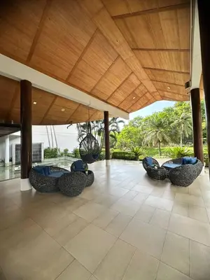 a pavilion with chairs under a wooden roof at Veloche group in Karon Beach