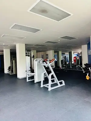 a gym with two treadmills and a ladder at Veloche group in Karon Beach