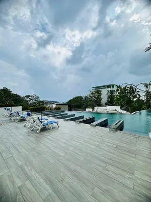 a group of chairs sitting on top of a swimming pool at Veloche group in Karon Beach