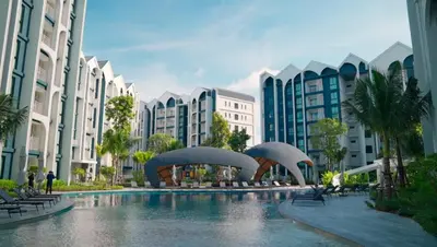 a pool in the middle of a city with buildings at Title HALO 1 - Modern 1BR Pool View Walk to Nai Yang Beach in Nai Yang Beach