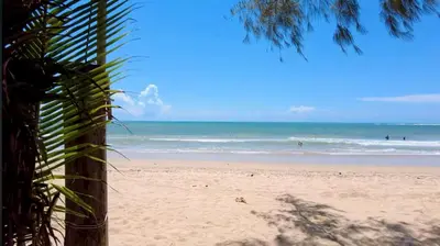 a view of a beach with people in the ocean at Title HALO 1 - Modern 1BR Pool View Walk to Nai Yang Beach in Nai Yang Beach