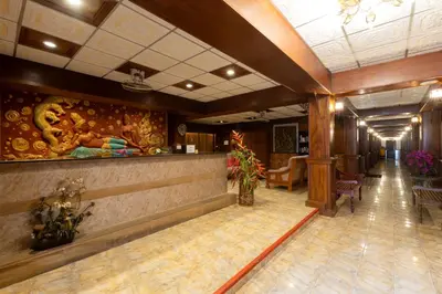 a lobby of a hotel with a bar and chairs at Kata Palace Phuket Hotel in Kata Beach