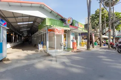 a group of shops on the side of a street at Kata Palace Phuket Hotel in Kata Beach