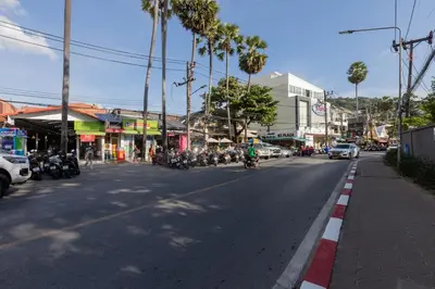 a group of motorcycles parked on a city street at Kata Palace Phuket Hotel in Kata Beach
