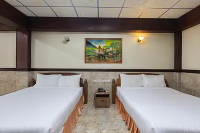 two twin beds in a room with at Kata Palace Phuket Hotel in Kata Beach