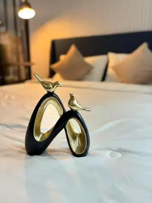 two gold birds sitting on top of a bed at Cen 1 bed room861 in Phuket Town