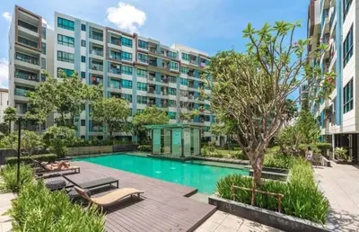 an apartment complex with a swimming pool in front of a building at Cen 1 bed room861 in Phuket Town