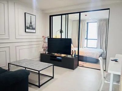 a living room with a television and a bed at Cen 1 bed room861 in Phuket Town