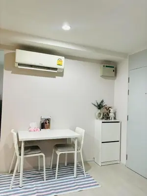 a white dining room with a white table and chairs at Cen 1 bed room861 in Phuket Town