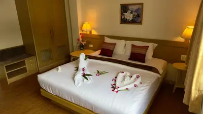 a hotel room with two beds with towels on them at Neptuna Kata Beach in Kata Beach