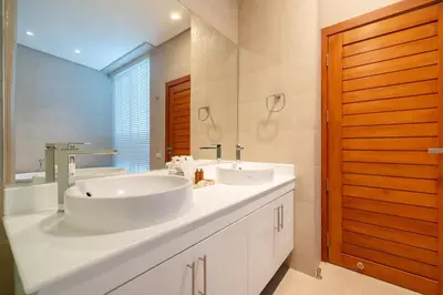 a bathroom with two sinks and a large mirror at The bay Cape Yamu Villa 10 in Phuket Town