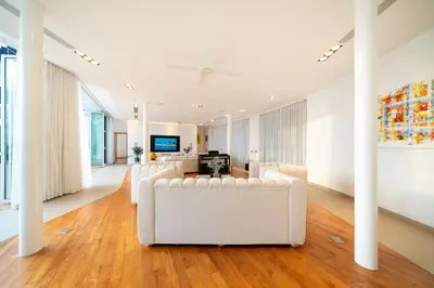 a living room with white couches and a painting at The bay Cape Yamu Villa 10 in Phuket Town