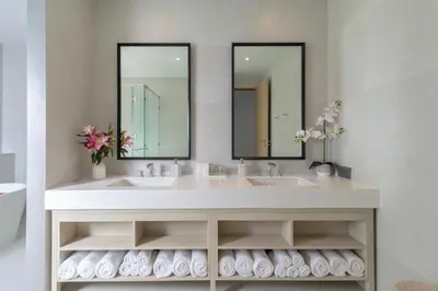 a bathroom with two sinks and two mirrors at Villa ANDA in Kamala Beach