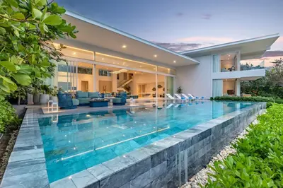 a swimming pool in the backyard of a house at Villa ANDA in Kamala Beach