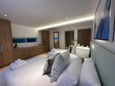 a hotel room with three beds with white pillows at The bay Cape Yamu Villa 2 in Ko Lek