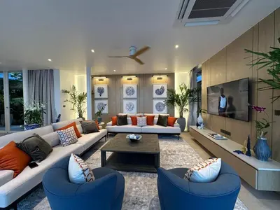 a living room with two couches and a tv at The bay Cape Yamu Villa 2 in Ko Lek