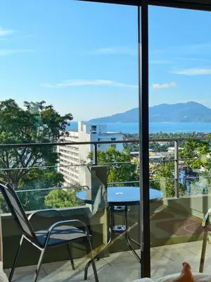 a view from a balcony with a table and chairs at Hill Bay Suites Hotel in Patong Beach