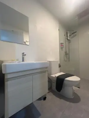 a white bathroom with a sink and a toilet at Hill Bay Suites Hotel in Patong Beach