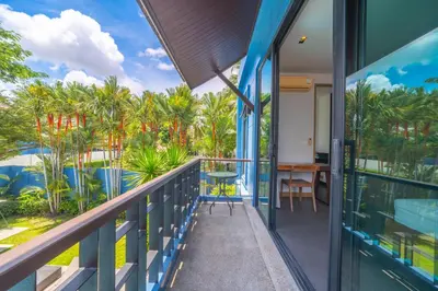 a balcony with a view of the ocean and palm trees at Bangtao Beach 3 bedroom private pool villa in a quiet area near Boat Avenue mono wings in Bang Tao Beach