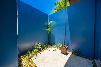 a swing in front of a blue wall at Bangtao Beach 3 bedroom private pool villa in a quiet area near Boat Avenue mono wings in Bang Tao Beach