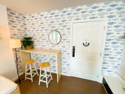 a bedroom with a blue and white patterned wall at Luxury Condo Near Patong Beach & Shopping Mall in Kathu