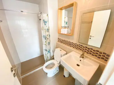 a bathroom with a toilet and a sink at Luxury Condo Near Patong Beach & Shopping Mall in Kathu