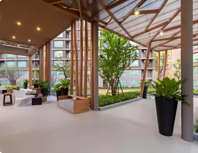 an empty lobby with plants in a building at Luxury Condo Near Patong Beach & Shopping Mall in Kathu