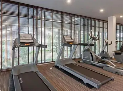 a gym with two treadmills and two exercise bikes at Luxury Condo Near Patong Beach & Shopping Mall in Kathu