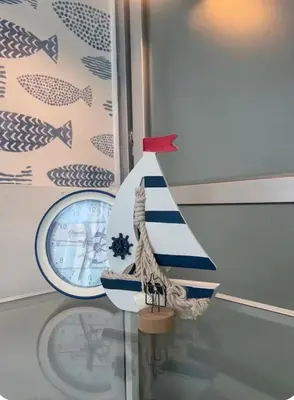 a small boat sitting on a glass table next to a clock at Luxury Condo Near Patong Beach & Shopping Mall in Kathu