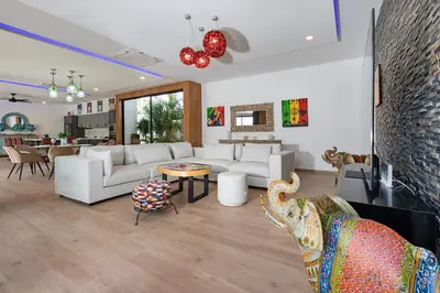 a living room with white couches and a table at Pattana Sun Villa - Modern 4 Bedrooms Villa with Pool in Ban Saiyuan (1)