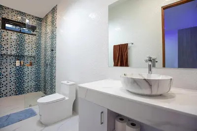 a bathroom with a sink and a toilet and a shower at Pattana Sun Villa - Modern 4 Bedrooms Villa with Pool in Ban Saiyuan (1)