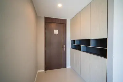 a hallway with a wooden door in a room at Surin Beach Serviced 3 Bedroom Sea View Apart-ment Comprehensive Facilities Resort Pool Gym Guest Choice in Surin Beach
