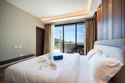 a hotel room with a bed with towels on it at Surin Beach Serviced 3 Bedroom Sea View Apart-ment Comprehensive Facilities Resort Pool Gym Guest Choice in Surin Beach