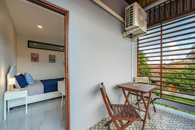 a room with a bedroom and a table and a bed at Areca Holiday Villa 3, Naiharn Beach in Rawai Beach
