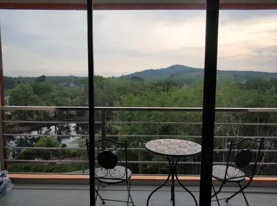a view of a balcony with a table and chairs at Nature View Residence in Ban Mai Salae