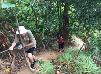 two people walking on a trail in the jungle at Nature View Residence in Ban Mai Salae