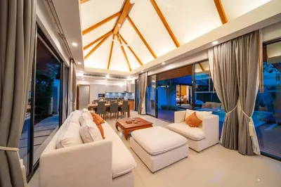 a living room with white furniture and a dining room at BangTao Anchan \u8c6a\u534e\u4e24\u5367 \u79c1\u4eba\u6cf3\u6c60 \u73b0\u4ee3\u5ea6\u5047\u5df4\u5398\u98ce in Layan Beach