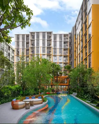an apartment complex with a swimming pool and buildings at The Base Rise in Phuket Town