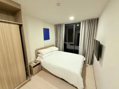 a small bedroom with a bed and a window at The Base Rise in Phuket Town